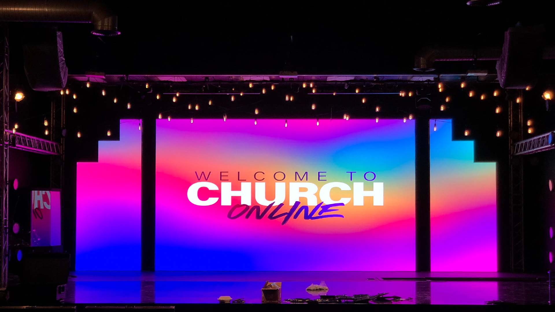 LED Display Buying Guide 2 - LED Display Price - LED Display Price Indoor LED display with a central screen and stepped side panels on a church stage