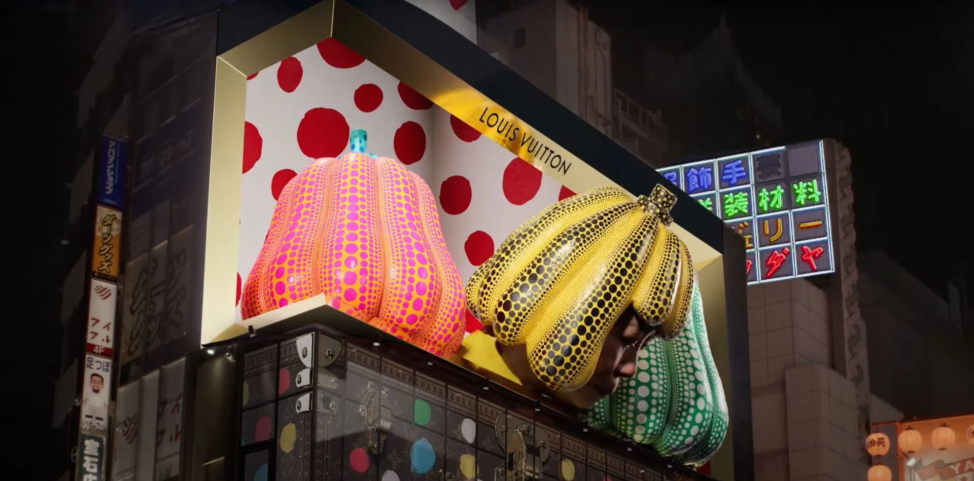 Corner LED billboard with colorful pumpkin artwork at night